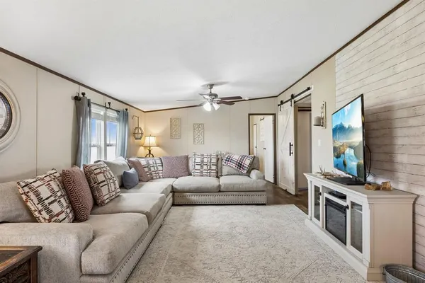 a living room with furniture and a flat screen tv