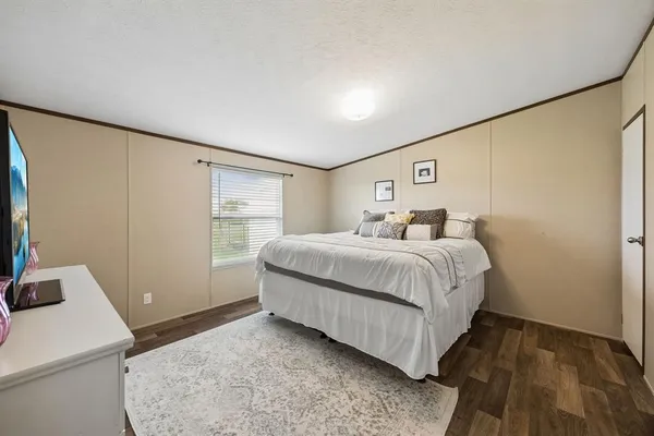 a bedroom with a bed and a table in it