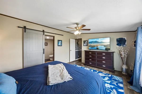 a bedroom with a bed and a dresser in it