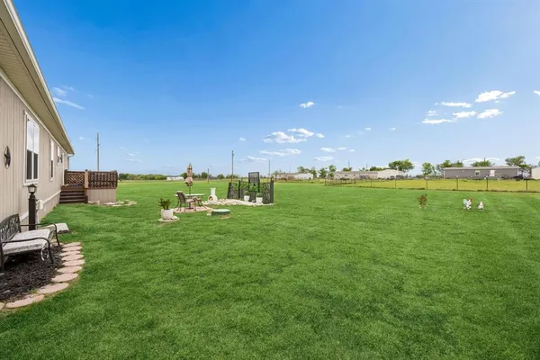 a backyard of a house with a table and chairs