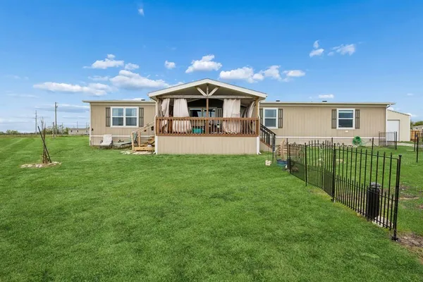 a house view with a sitting space and garden