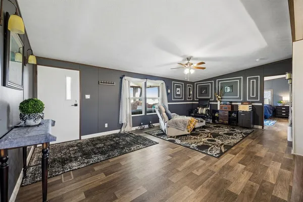 a living room with furniture and wooden floor