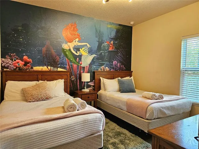 a bedroom with a bed and window