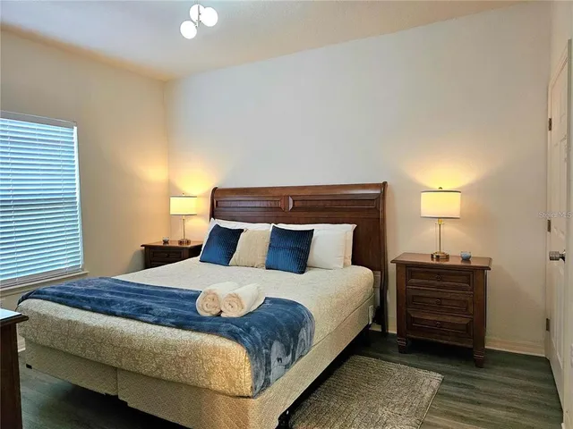 a bedroom with a bed and a night stand