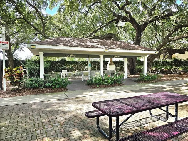 a view of a patio with table and chairs under an umbrella