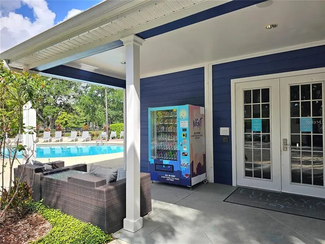 a view of a porch with furniture and floor to ceiling window