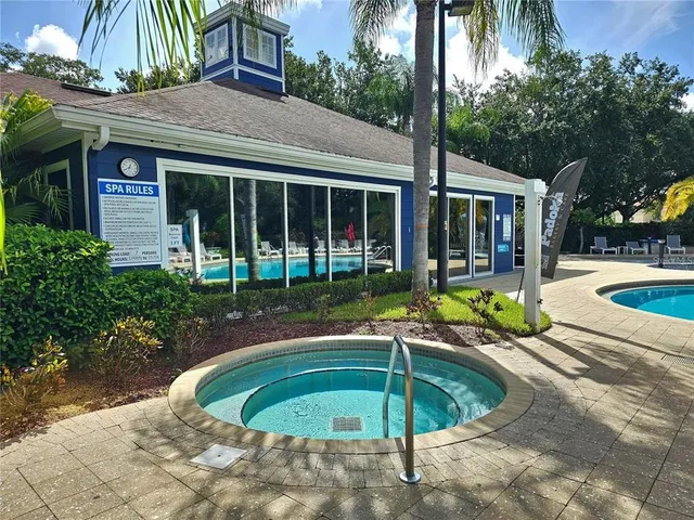 a house view with a swimming pool and outdoor seating