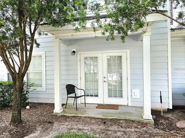 a view of a house with a backyard and a tree