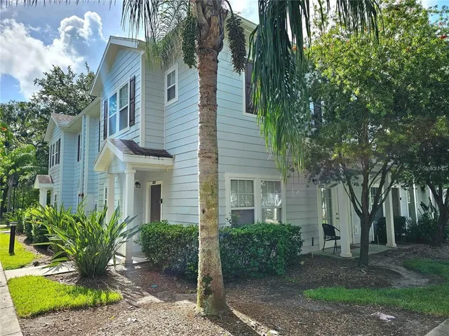 a view of a house with a yard and plants