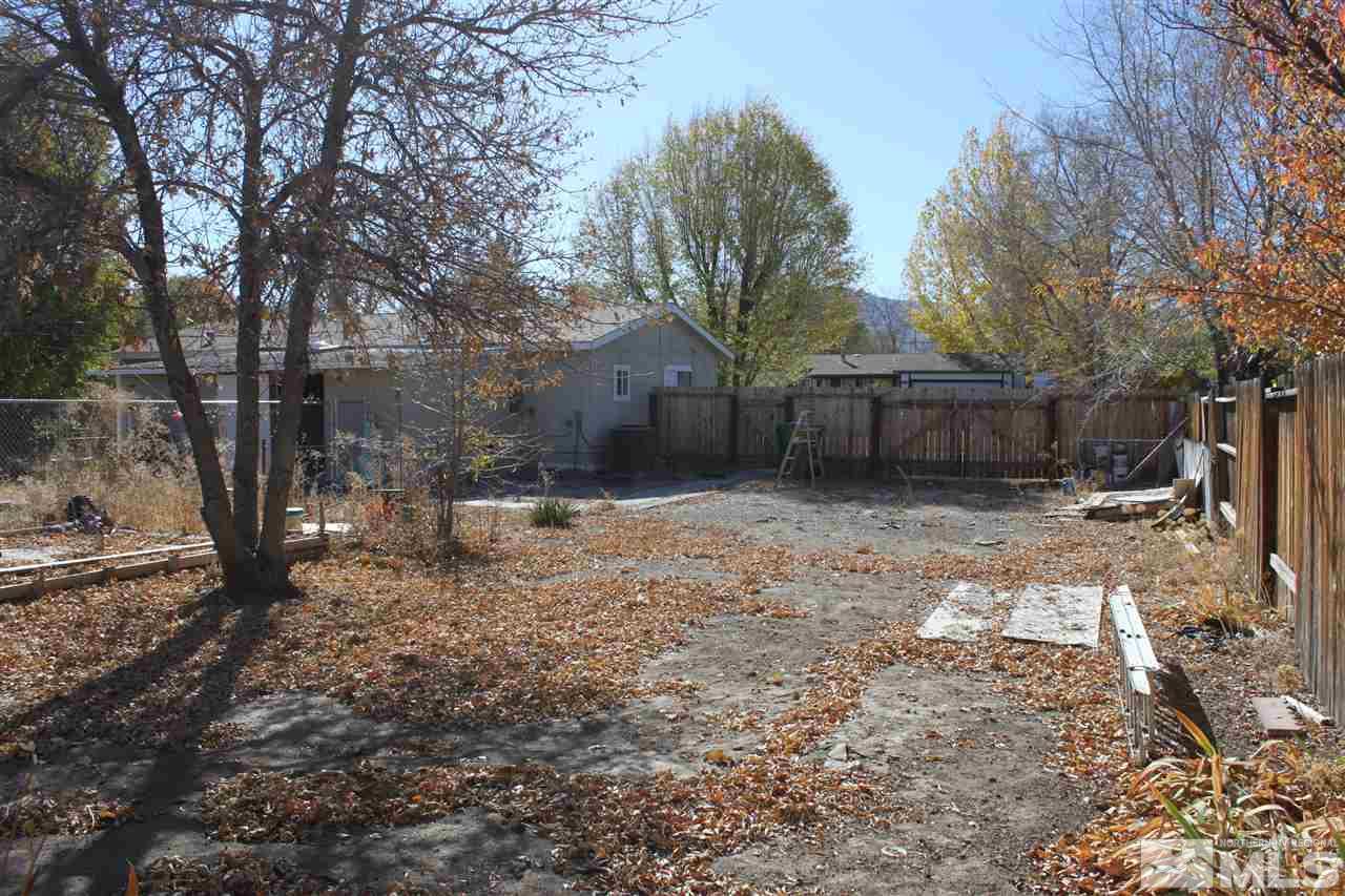 17645 Macaw Lane Reno, NV 89508 - Photo 17 of 19 a backyard of a house with large trees and outdoor seating