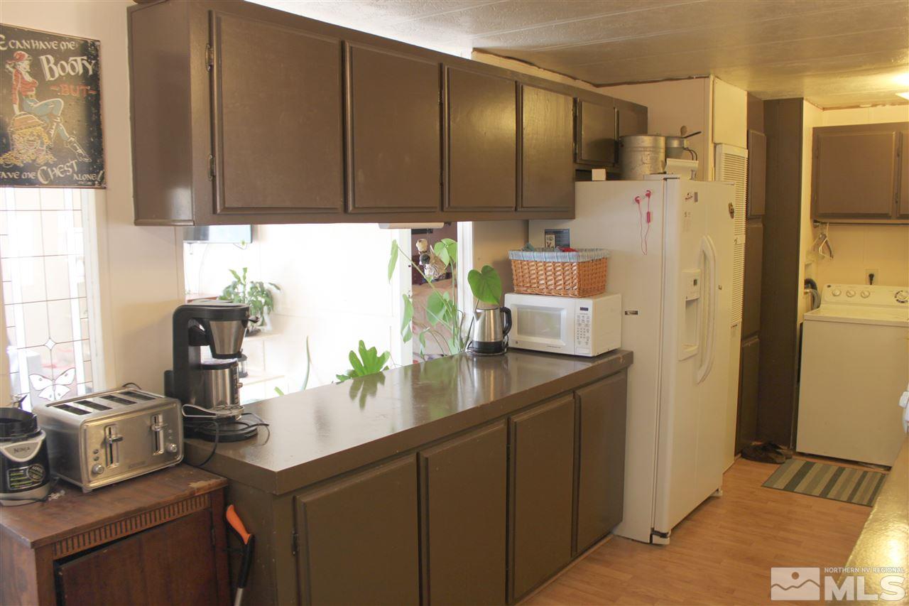 17645 Macaw Lane Reno, NV 89508 - Photo 4 of 19 a kitchen with stainless steel appliances a sink cabinets and a window