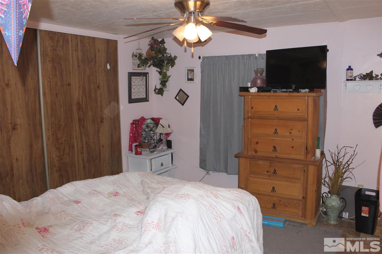 17645 Macaw Lane Reno, NV 89508 - Photo 6 of 19 a bedroom with a bed and a flat tv screen on dresser