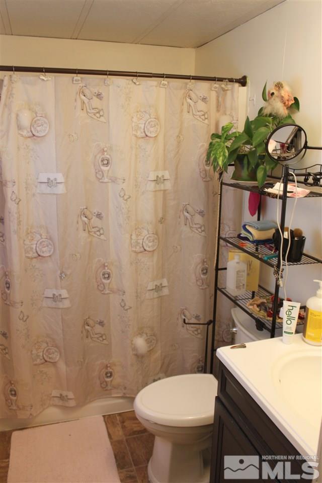17645 Macaw Lane Reno, NV 89508 - Photo 7 of 19 a bathroom with a sink a toilet and shower