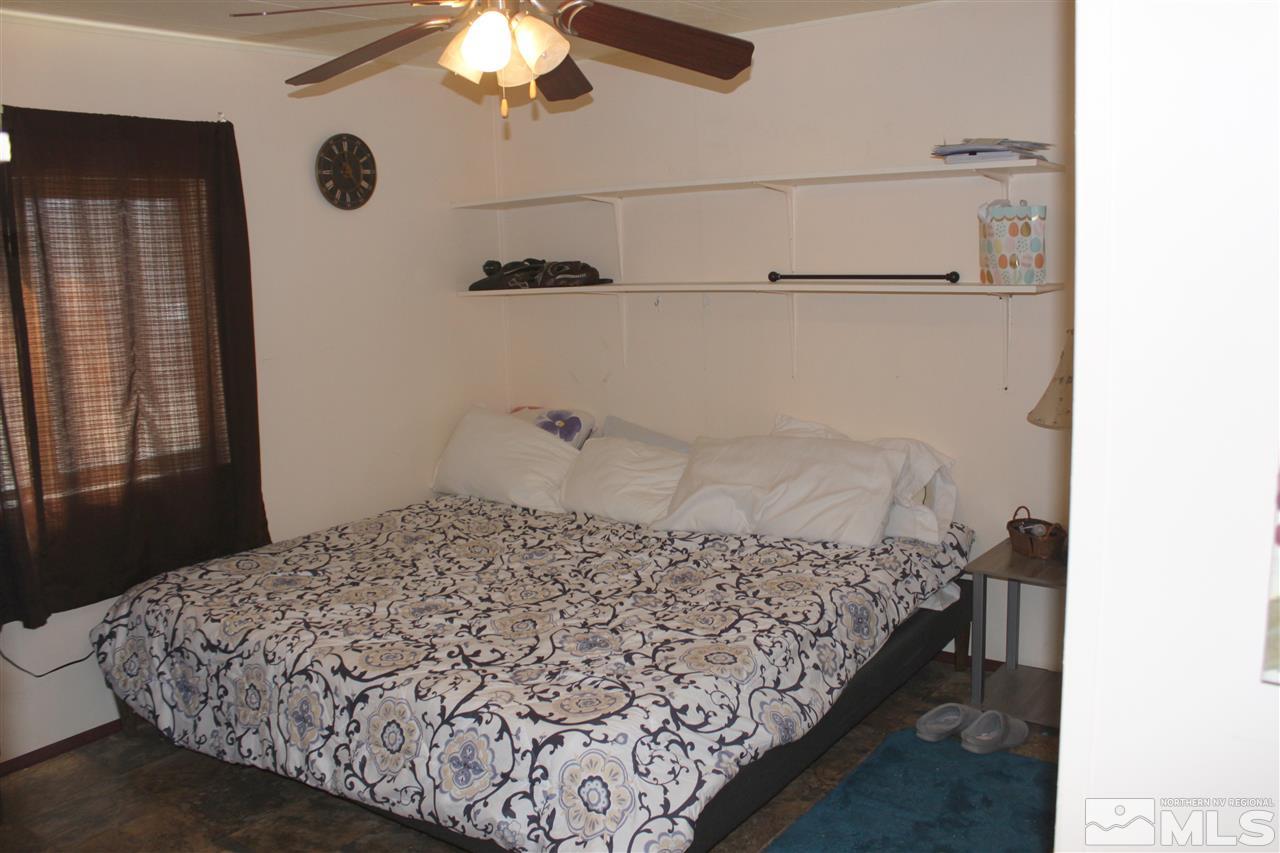 17645 Macaw Lane Reno, NV 89508 - Photo 8 of 19 a bed sitting in a bedroom next to a window