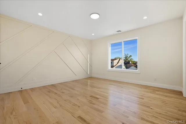 a spacious bathroom with a tub sink and mirror