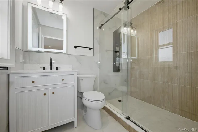 an empty room with wooden floor and window