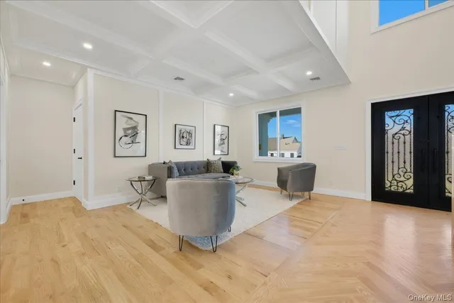 a living room with furniture a large window and dresser