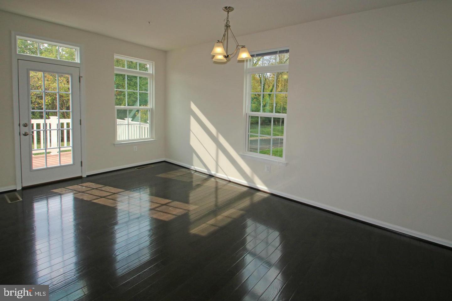 2482 Baldwin Crescent Northeast Washington, DC 20018 - Photo 11 of 28 an empty room with wooden floor and windows