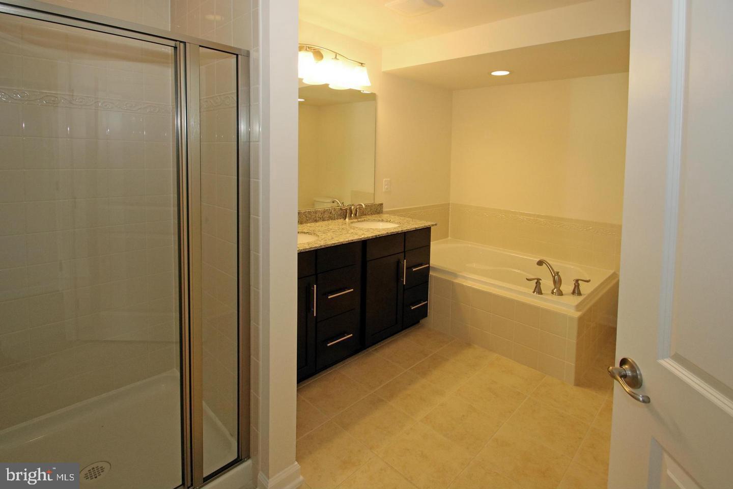 2482 Baldwin Crescent Northeast Washington, DC 20018 - Photo 20 of 28 a bathroom with a sink mirror and a shower