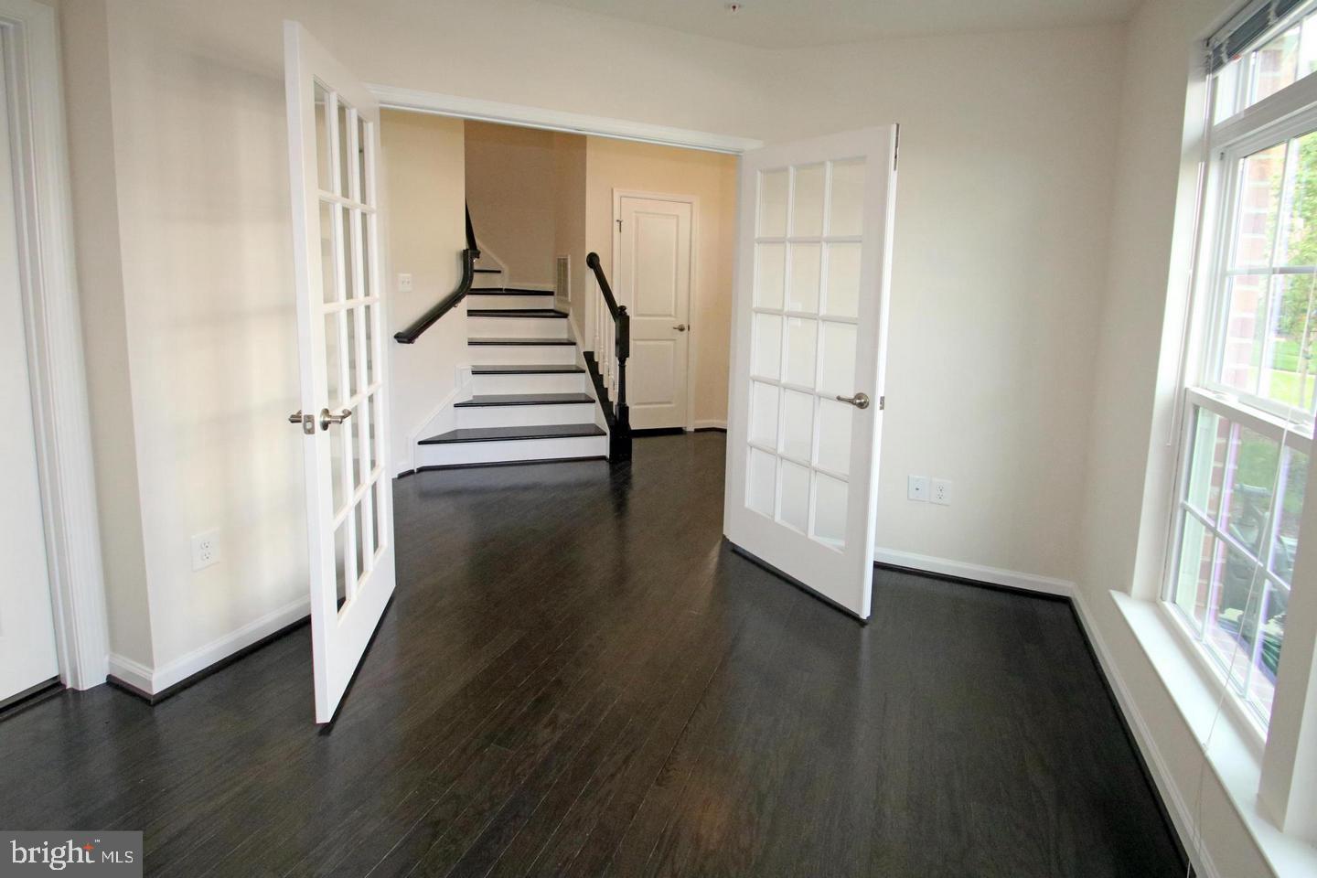 2482 Baldwin Crescent Northeast Washington, DC 20018 - Photo 4 of 28 an empty room with wooden floor and windows