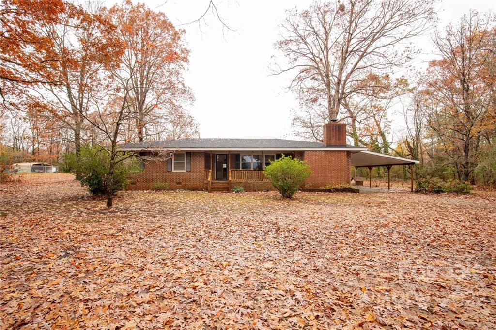 3169 Pink Plyler Road Lancaster, SC 29720 - Photo 2 of 39 a front view of a house with a garden