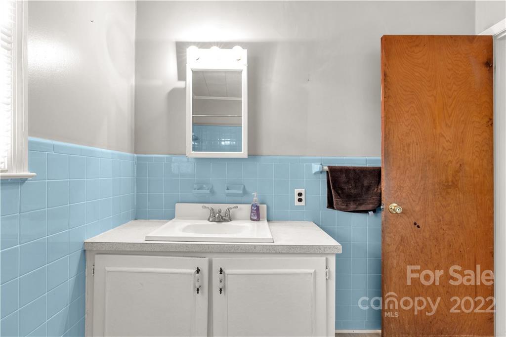 3169 Pink Plyler Road Lancaster, SC 29720 - Photo 25 of 39 a bathroom with a sink and a washer