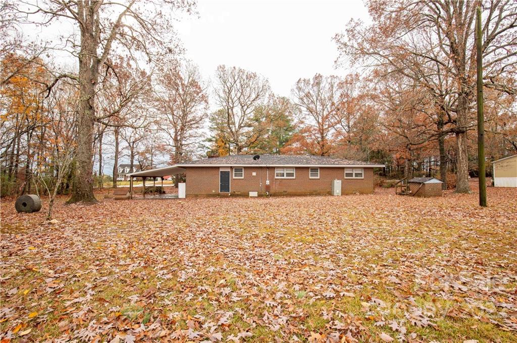 3169 Pink Plyler Road Lancaster, SC 29720 - Photo 26 of 39 a front view of a house with a yard covered with snow and trees