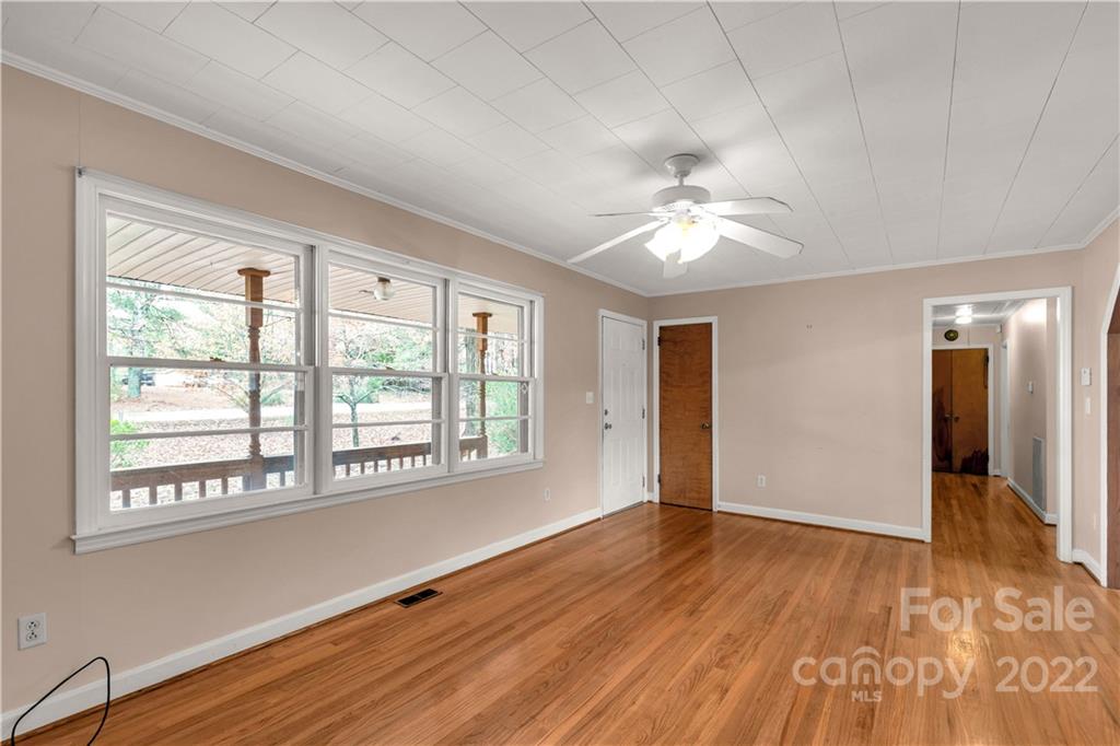 3169 Pink Plyler Road Lancaster, SC 29720 - Photo 7 of 39 a view of an empty room with a window and wooden floor