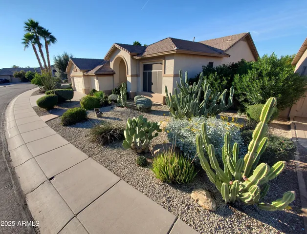 a front view of a house with a garden