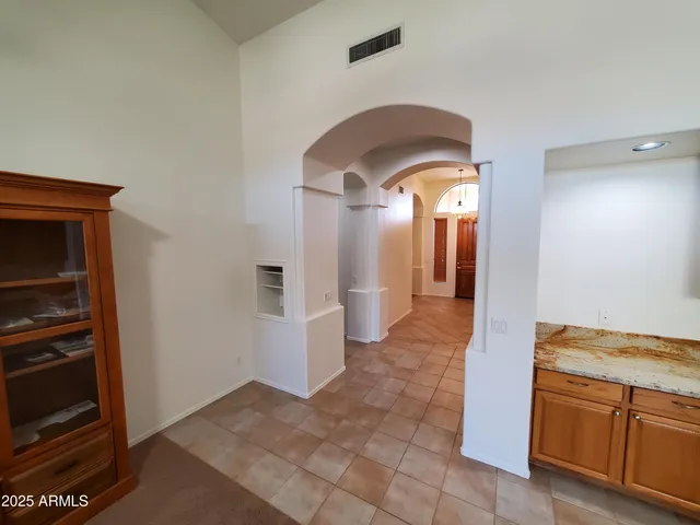 a large kitchen with stainless steel appliances granite countertop a stove a sink dishwasher and a refrigerator