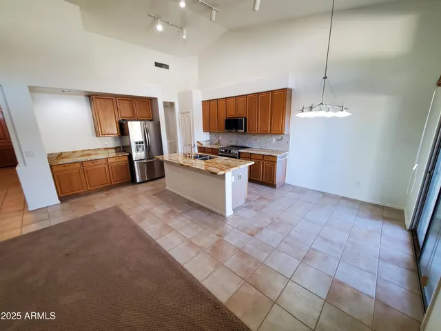 a kitchen with granite countertop a sink and a stove top oven