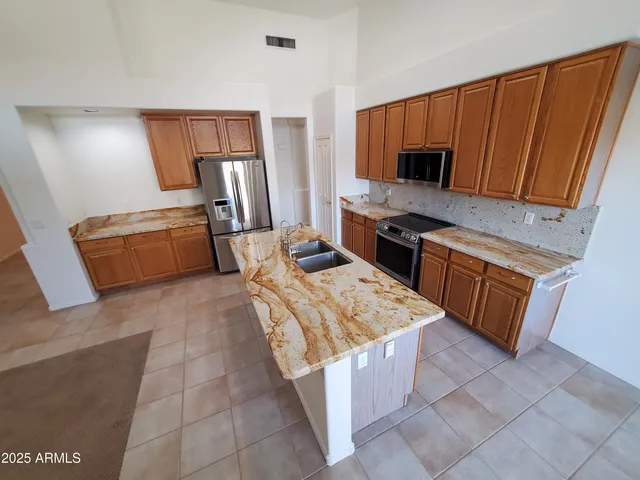 a view of an empty room with a fireplace and a window