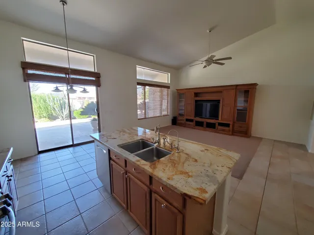 a kitchen with a refrigerator sink and cabinets