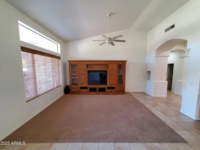 a bed sitting in a room next to a window
