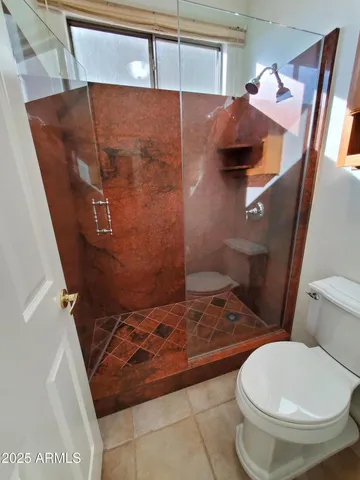 a view of a livingroom with a ceiling fan and carpet
