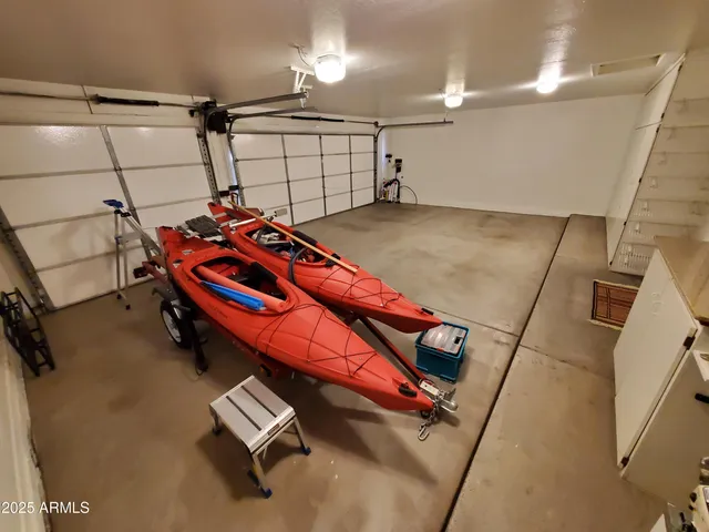 a view of a patio with table and chairs with wooden floor and plants