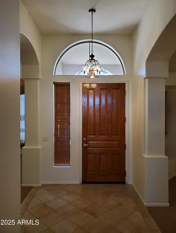 a view of a hallway with a chandelier