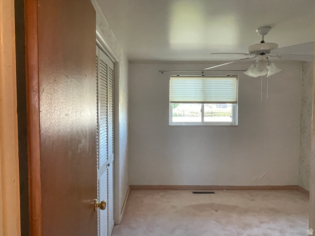 438 East Main Street Elsinore, UT 84724 - Photo 33 of 43 Interior room featuring a ceiling fan with integrated lighting, a window with horizontal blinds, carpet flooring, and a louvered bi-fold closet door