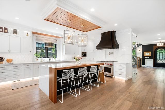 a large white kitchen with a large counter top