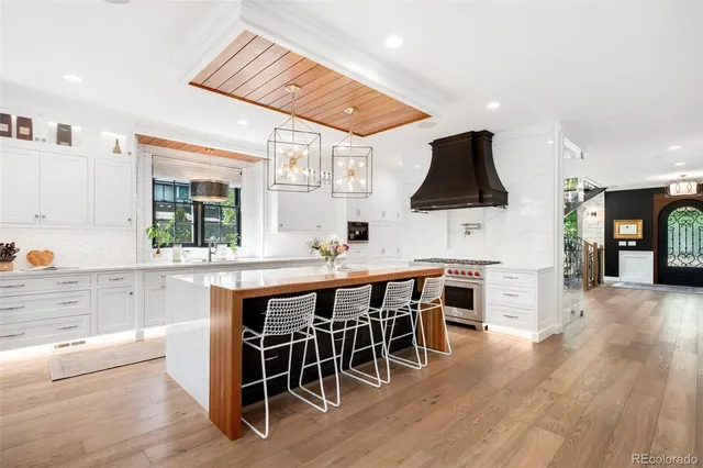 a large white kitchen with a large counter top