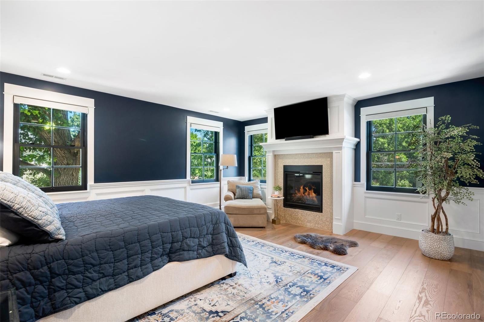 1296 South York Street Denver, CO 80210 - Photo 24 of 49 a living room with a couch a window and a fireplace