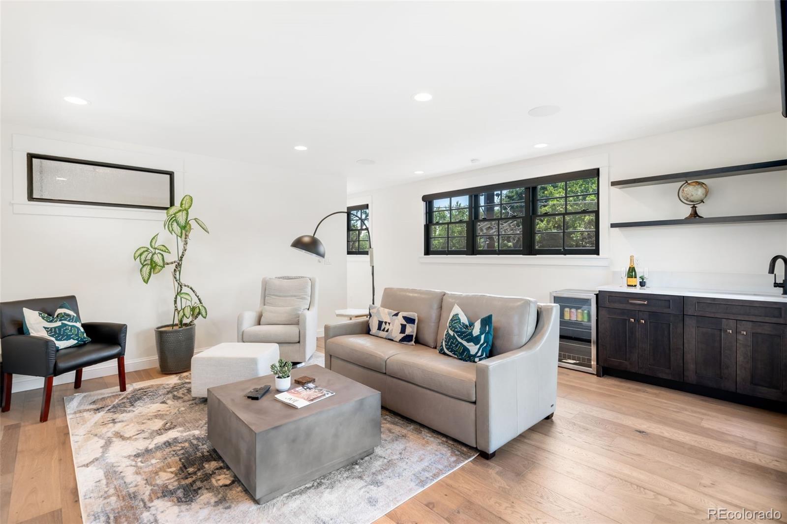 1296 South York Street Denver, CO 80210 - Photo 36 of 49 a living room with furniture a rug and a window
