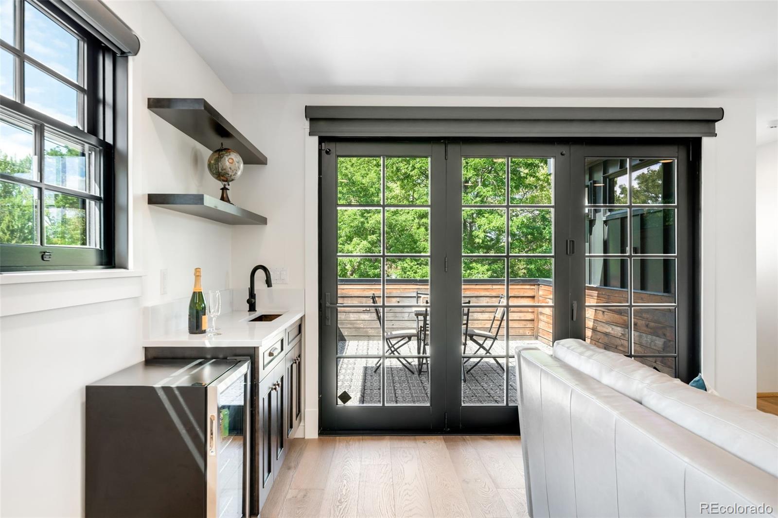 1296 South York Street Denver, CO 80210 - Photo 37 of 49 a kitchen with stainless steel appliances a sink a stove and a refrigerator