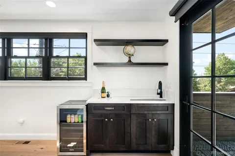 a view of a kitchen with a sink and a refrigerator
