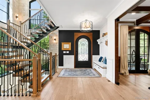 a view of entryway and hall with wooden floor