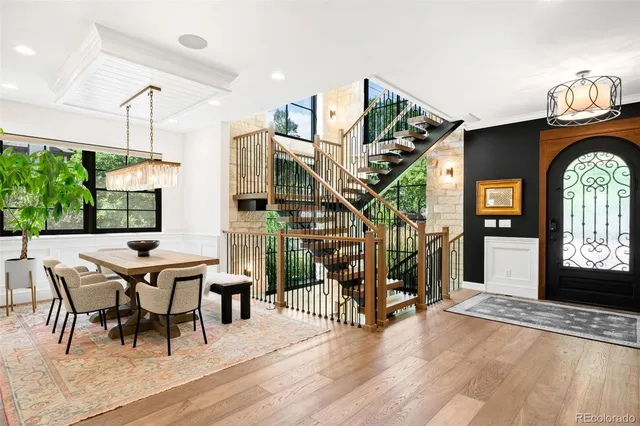 a dining room with furniture entryway and wooden floor