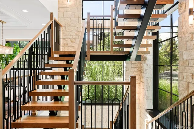 a living room with furniture a fireplace and a large window