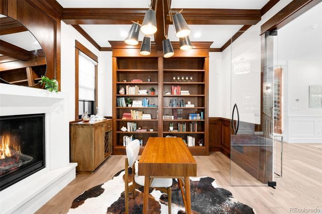 a kitchen with stainless steel appliances a table chairs sink and cabinets