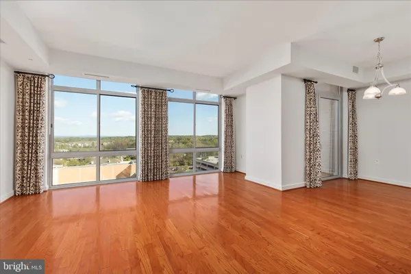 a view of livingroom with furniture and large windows