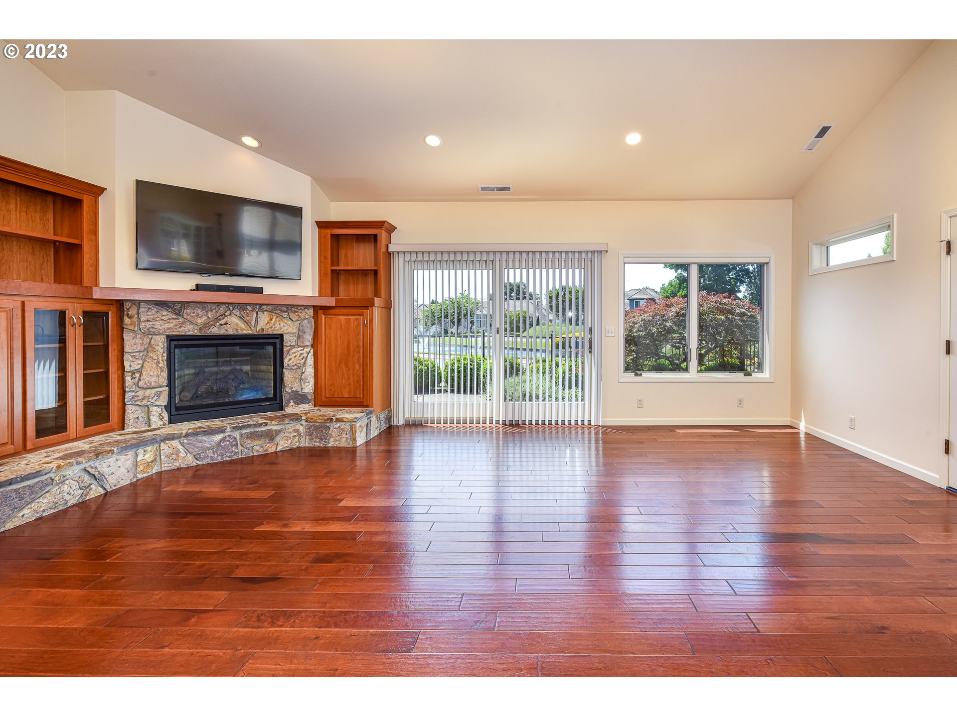 2002 Lake Shore Drive Eugene, OR 97408 - Photo 15 of 37 an empty room with fireplace flat screen tv and windows